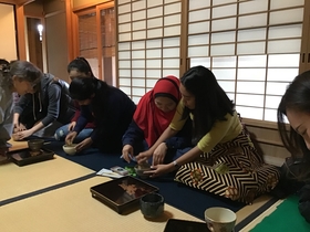 International students making tea using a chasen
