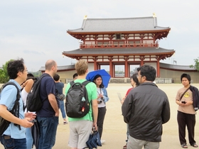Participants listening to an explanation at the Suzaku Gate