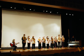 Indonesian students playing the traditional musical instrument Angklung